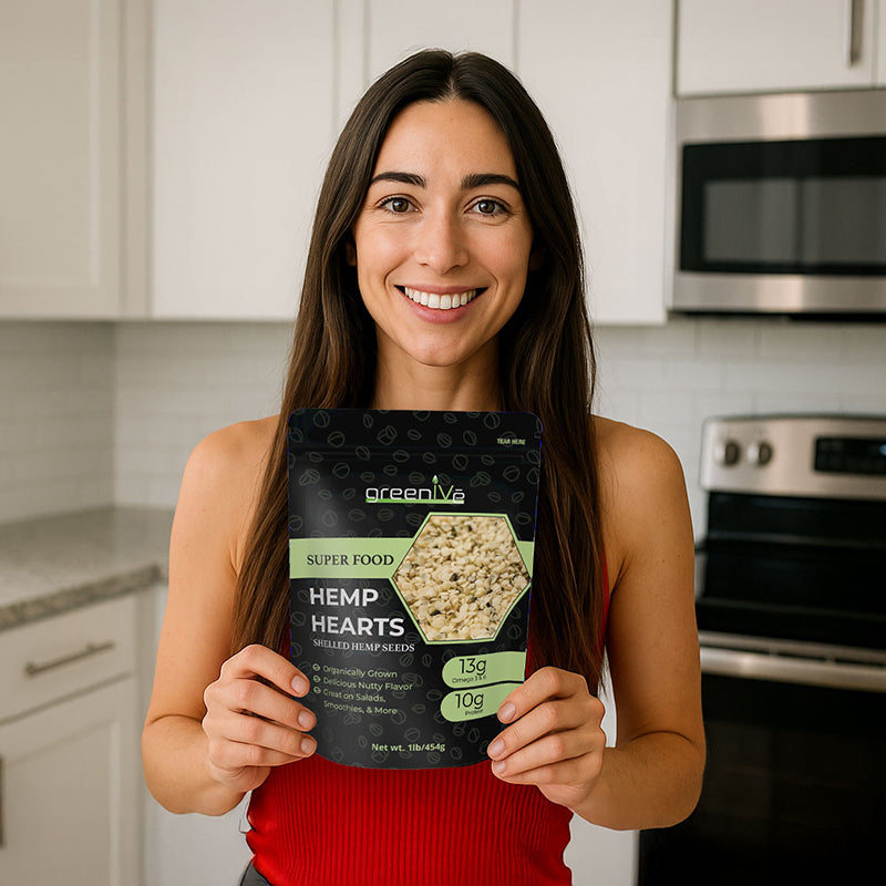 Woman holding a package of greenlife hemp hearts in a kitchen.